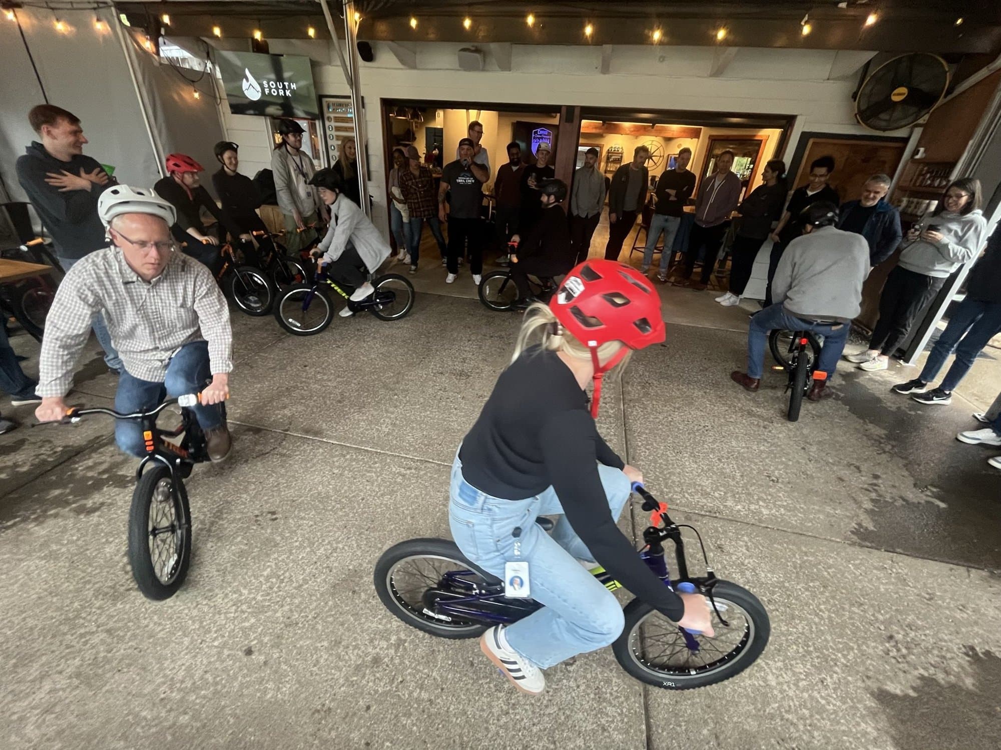 A team riding bikes they built together during an event