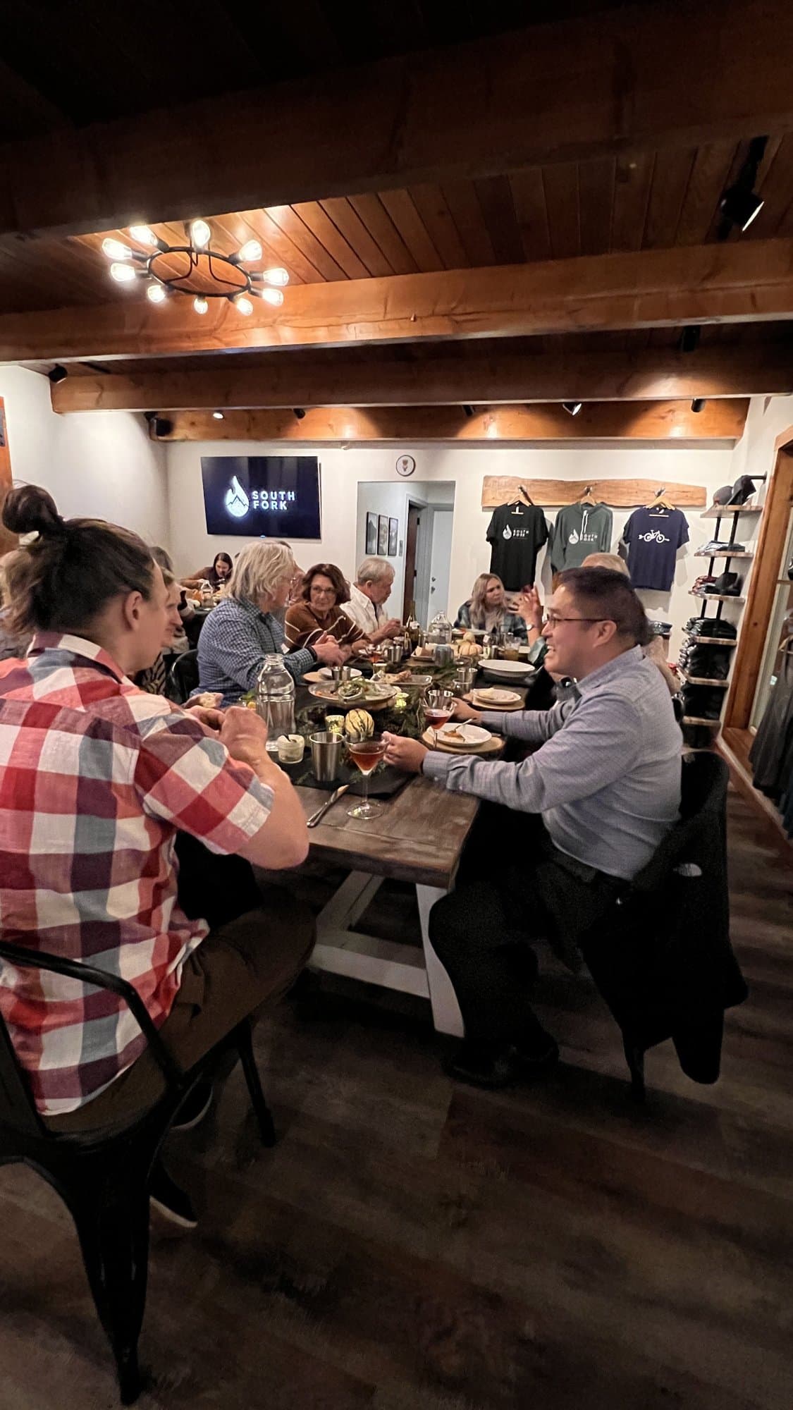 A full room of neighbors at long tables