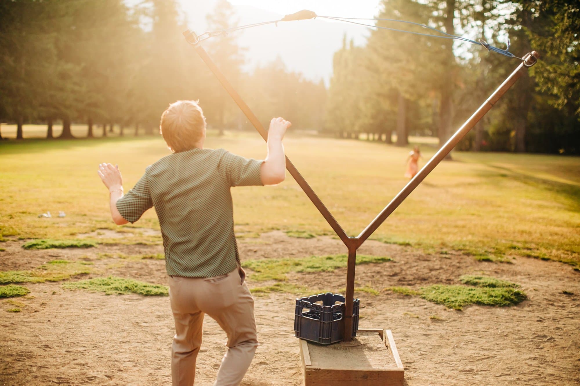 A guest launching a ball with the giant slingshot on the lawn