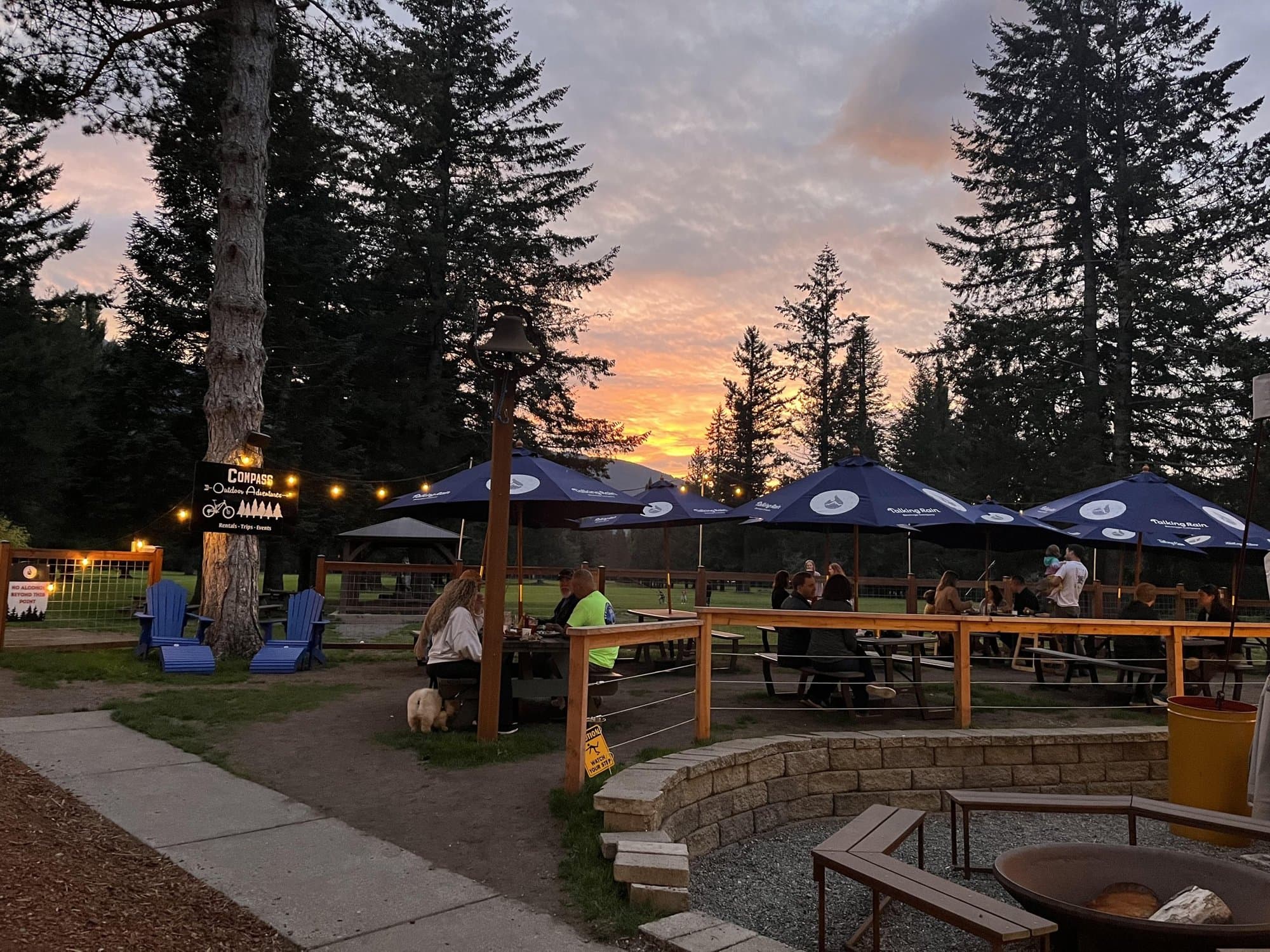 The South Fork beer garden at sunset, string lights over umbrellas