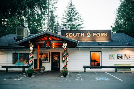 The South Fork storefront at dusk, dressed in holiday garlands