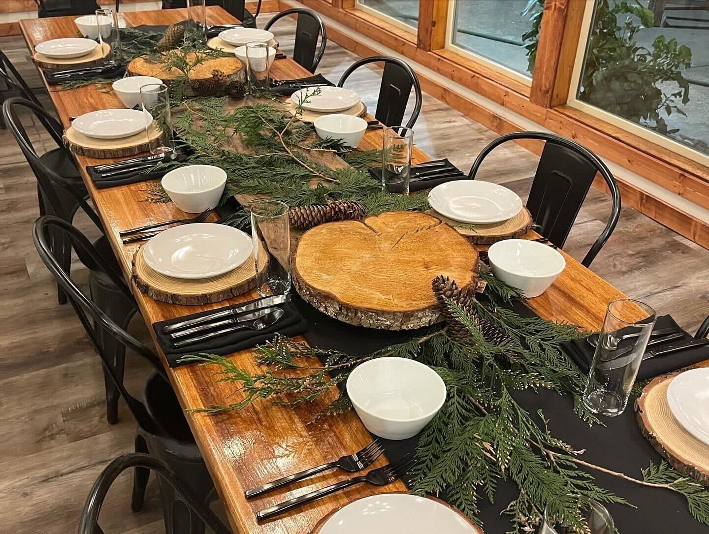 A long table set family style with greenery