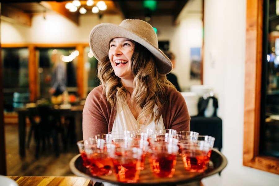 A host serving a tray of welcome cocktails