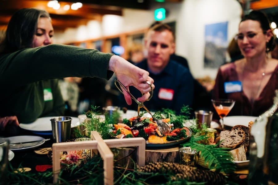 Guests passing a family-style platter